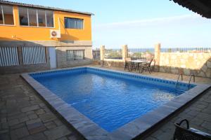 a swimming pool in front of a house at Pousada Recanto da Enseada in Cabo de Santo Agostinho