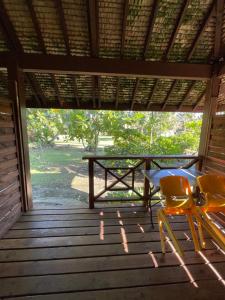 a table and a chair on a porch at Punatea Village in Afaahiti