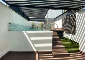 a staircase leading up to a house with a swimming pool at Cadillac Hotel Boutique in Mexico City