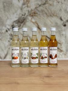 a group of four bottles of honey on a table at City Apartment nahe Schönbrunn 13 in Vienna
