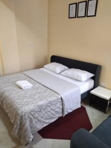 a bedroom with a large bed with two white pillows at Ayo's Vacation Home in Thika +16 photos