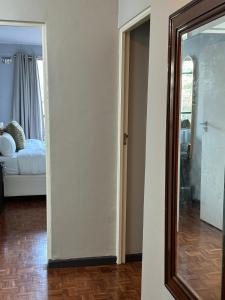 a room with a mirror and a bedroom with a bed at HOPE-always in Cape Town