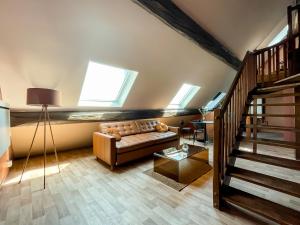 a living room with a couch and some windows at Casa Andrea - Hypercentre & climatisation in Metz