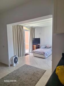 a bedroom with a bed and a desk and a window at comfort marine 2 in Hurghada +78 photos