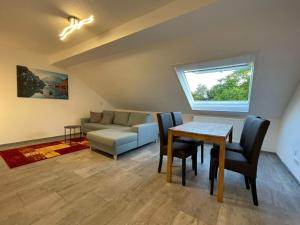 a living room with a table and a couch at Messe- und Ferienwohnung Feucht in Feucht