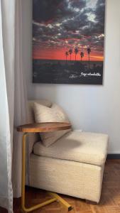 a living room with a table and a picture on the wall at HOPE-always in Cape Town