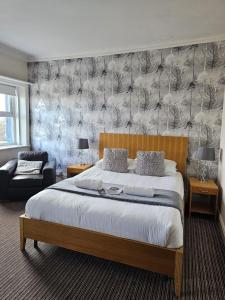 a bedroom with a king sized bed and a couch at The New Brighton Hotel in New Brighton