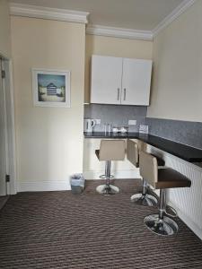 a kitchen with two chairs and a counter top at The New Brighton Hotel in New Brighton