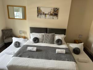 a bedroom with a large bed with black and white pillows at The New Brighton Hotel in New Brighton