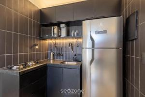 a kitchen with a stainless steel refrigerator and a sink at Studio Moderno em Lago Norte SHL0105 in Brasilia +5 photos