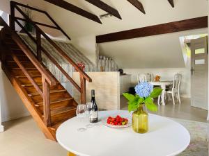 a white table with a vase of flowers and wine glasses at Willa Solina in Solina