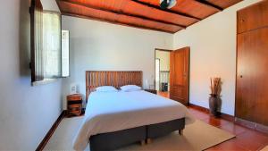 a bedroom with a large bed in a room at Rustic Holiday House in the Natural Park in Alcobertas