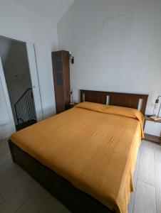 a bedroom with a large bed with a brown bedspread at Berretta Rossa in Bologna +8 photos