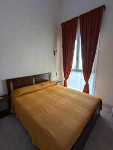 a bedroom with a large bed with red curtains at Berretta Rossa in Bologna