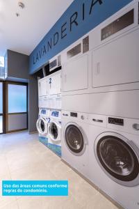 a laundry room with two washer and dryer machines at Lobie Casa Mauá in Rio de Janeiro