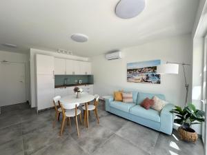 a living room with a blue couch and a table at Blue Bay Apartment Nerezine in Nerezine +32 photos