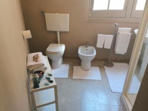 a small bathroom with a toilet and a sink at Casa Argentieri 3 in Trapani +16 photos