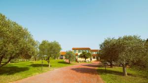 a brick road in front of a building with trees at Agriturismo Eva - Venice Airport in Favaro Veneto