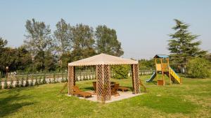 a gazebo and a playground with a slide at Agriturismo Eva - Venice Airport in Favaro Veneto