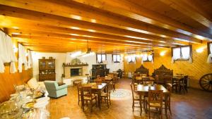 a restaurant with tables and chairs and a fireplace at Agriturismo Eva - Venice Airport in Favaro Veneto