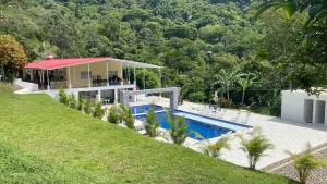 a house with a swimming pool in front of a house at Finca Villa Carmen, Vía Magdalena in Villeta +31 photos
