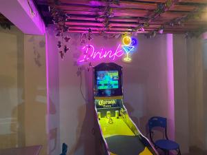 a video game machine in a room with a neon sign at Finca Villa Carmen, Vía Magdalena in Villeta
