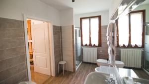 a bathroom with a sink and a toilet and windows at Agriturismo Eva - Venice Airport in Favaro Veneto +73 photos