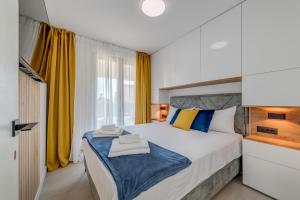 a bedroom with a large bed with yellow curtains at Panorama Coastal Haven in Split