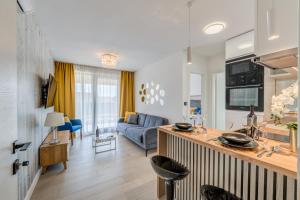 a kitchen and living room with a blue couch at Panorama Coastal Haven in Split