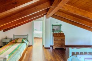 a attic bedroom with two beds and a mirror at Villa Lefka Stunning Seaside Villa in Corfu with Private Gardens in Melíkia
