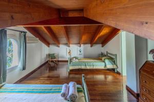 a bedroom with a bed and wooden ceilings at Villa Lefka Stunning Seaside Villa in Corfu with Private Gardens in Melíkia