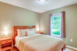 a bedroom with a large bed and a window at Campton Cottage with Hot Tub, Near Hiking and Climbing in Rogers