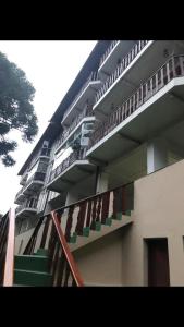 a large building with stairs in front of it at Aconchegante Apartamento in Campos do Jordão