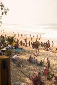 a large group of people on a beach at Graffi Beach House in Florianópolis +154 photos