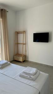 a bedroom with a white bed with towels on it at Lumra Rooms in Lukov&euml;