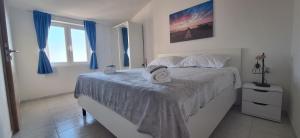 a bedroom with a bed with a hat on it at Family and pet friendly apartment Frankopan Croatia in Šmrika