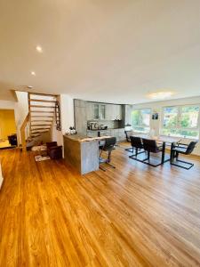 a large living room with wooden floors and a kitchen at Ferienwohnung Burgblick in Waldkirch