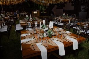 a long wooden table with wine glasses and chairs at Finca Hotel Villa Clara in Chinchiná