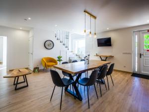 a dining room with a wooden table and chairs at Casa do Demo in Melgaço