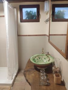 a bathroom with a sink on a wooden table at La Chimenea Casa Rural in Granada +12 photos