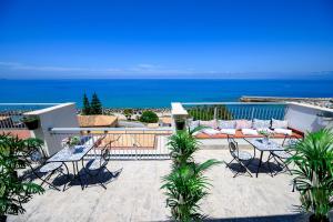 a patio with tables and chairs and the ocean at Exclusive B&B in Pizzo +32 photos