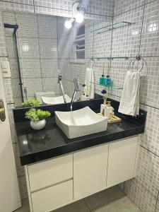 a bathroom with a sink and a mirror at Linda casa pertinho de Tiradentes in São João del Rei +27 photos