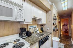 a kitchen with a sink and a microwave at A Place At The Beach 122 in Atlantic Beach