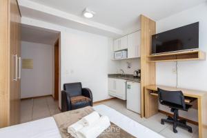 une pièce avec un bureau et des chaises et une cuisine dans l'établissement Flat Moderno p/ Negócios em Asa Norte BHY0614, à Brasilia