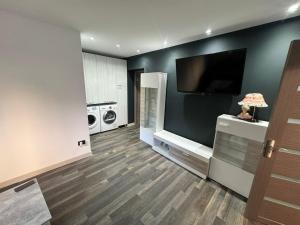 a living room with a flat screen tv on a wall at Apartment Trendy Brian in Vulcan