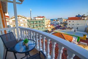 a balcony with a table and a view of a city at Hotel Ilion in Paralia Katerinis