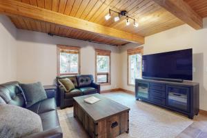 a living room with a couch and a flat screen tv at Wild Horse Hideaway in Incline Village