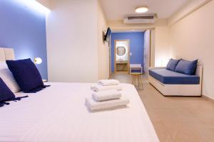 a large room with two beds and a couch at Hotel Ilion in Paralia Katerinis