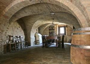 a dining room with a table and chairs in a building at Casa Briga in Montesilvano