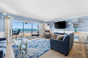 a living room with a view of the ocean at Sunset Terrace 109 in Bradenton Beach